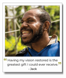 Smiling man named Jack from Papua New Guinea, wearing a blue shirt, with quote: “Having my vision restored is the greatest gift I could ever receive.”
