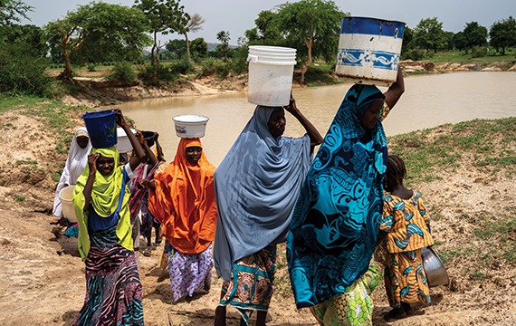 In Nigeria women collect water from the river, boreholes are needed to help prevent Neglected Tropical Diseases.