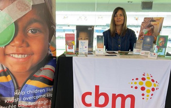 Elizabeth at the cbm stand, during the 2023 Prayer Breakfast.