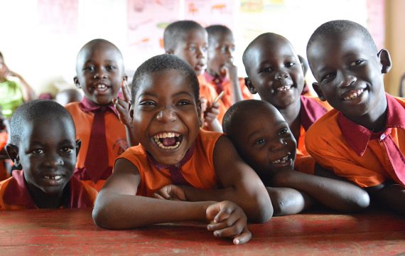 aboutus-ourvalues Sure Prospects Primary school is an inclusive school. It is a partner school with CoRSU hospital, CBM’s partner in Entebbe district in Uganda. Please refer to respective report.
Here Shamilla a 12 year old girl with other pupils in the classroom. Shamilla has cerebral palsy and associates well with other children in this school.